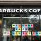 A Starbucks location in New York City displays a welcoming sign in the window in May 2020.